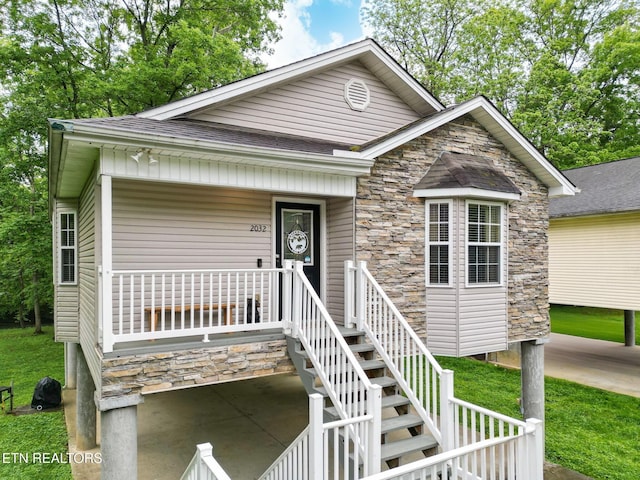 2032 Slippery Rock Cir, Sevierville, TN 37862 - view of front of home featuring stone siding, a shingled roof, and covered porch