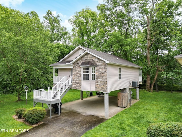 2032 Slippery Rock Cir, Sevierville, TN 37862 - back of house with a carport, a yard, stone siding, and concrete driveway
