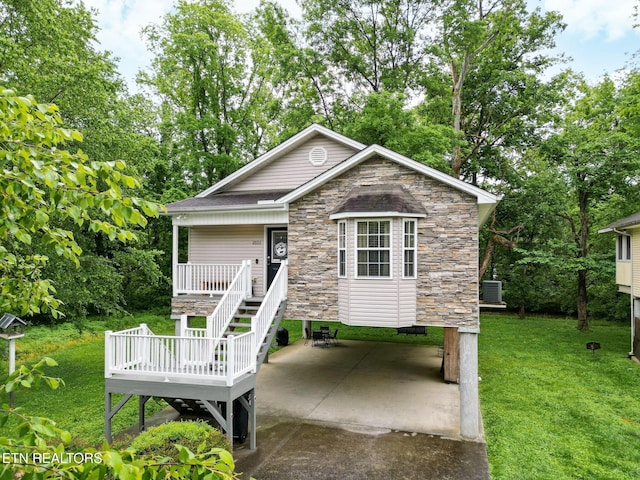 2032 Slippery Rock Cir, Sevierville, TN 37862 - view of front of property with stone siding, a front lawn, a patio, view of wooded area, and a wooden deck