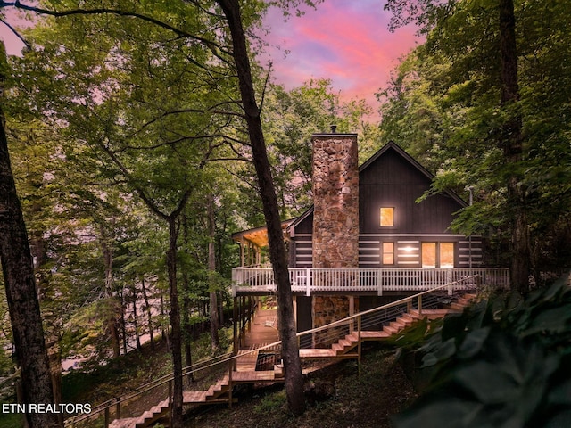 1226 Buzzard Roost Rd, Spring City, TN 37381 - back of property at dusk with stairs, a deck, and a chimney