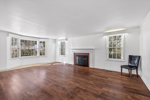 1302 Hampshire Pike, Columbia, TN 38401 - unfurnished living room with a brick fireplace and wood finished floors