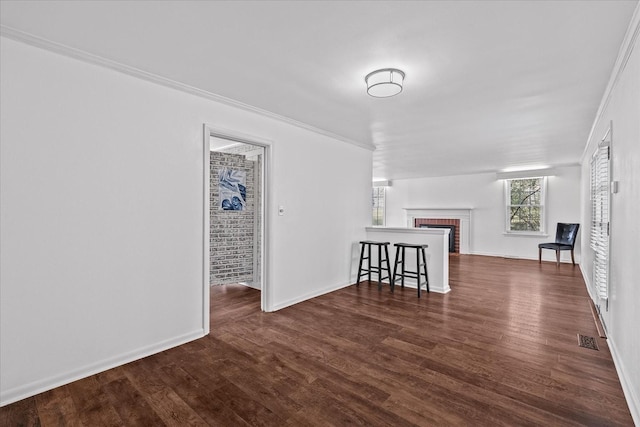 1302 Hampshire Pike, Columbia, TN 38401 - living room with dark wood-type flooring, a fireplace, and crown molding