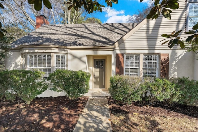 1302 Hampshire Pike, Columbia, TN 38401 - view of front of property featuring roof with shingles, a chimney, and stucco siding