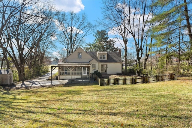1302 Hampshire Pike, Columbia, TN 38401 - back of house with a fenced front yard, a sunroom, a chimney, and a shed