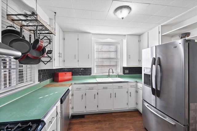 1302 Hampshire Pike, Columbia, TN 38401 - kitchen featuring appliances with stainless steel finishes, white cabinets, dark wood-style flooring, tasteful backsplash, and light countertops