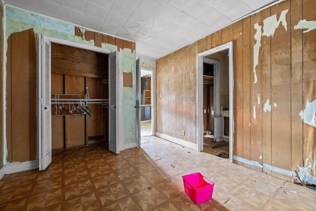 2727 Old Tilton Rd, Dalton, GA 30721 - unfurnished bedroom with a closet and wood walls
