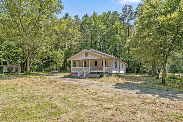 2727 Old Tilton Rd, Dalton, GA 30721 - view of front of home featuring covered porch, a front lawn, and a view of trees