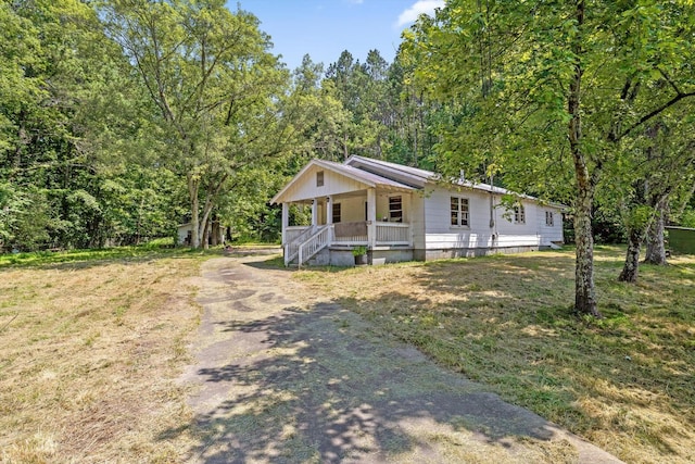 2727 Old Tilton Rd, Dalton, GA 30721 - view of front of house with a porch, driveway, and a forest view