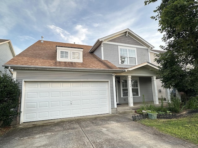 188 Sophie Dr, Antioch, TN 37013 - view of front of property with a porch, concrete driveway, an attached garage, and a shingled roof