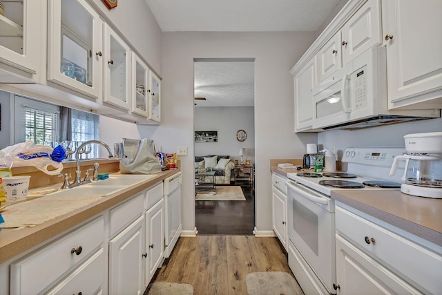 411 Churchill Xing, Madison, TN 37115 - kitchen with white appliances, light wood-style flooring, light countertops, white cabinets, and glass insert cabinets