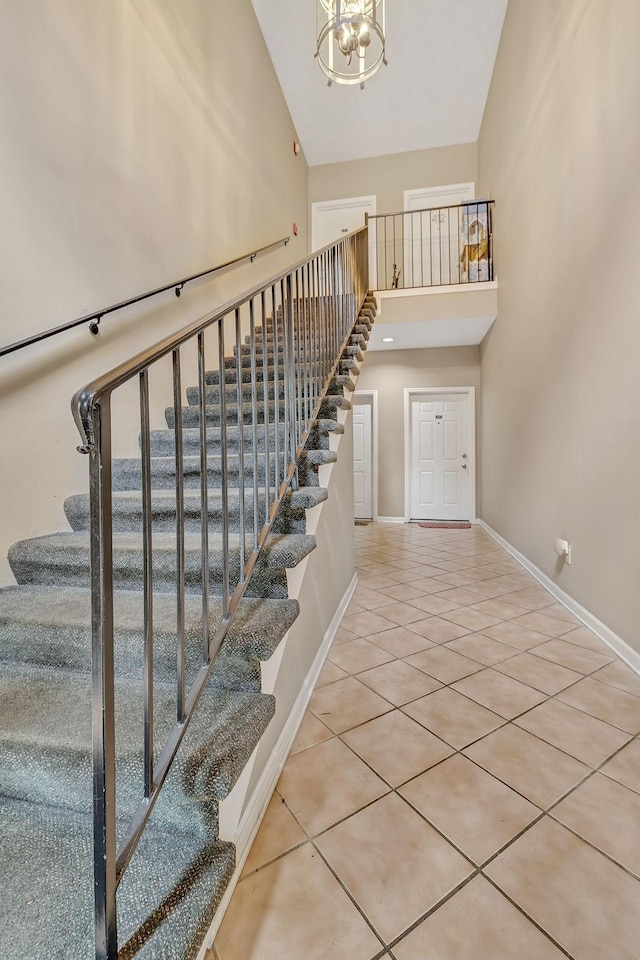 411 Churchill Xing, Madison, TN 37115 - staircase with a chandelier, a high ceiling, and tile patterned floors