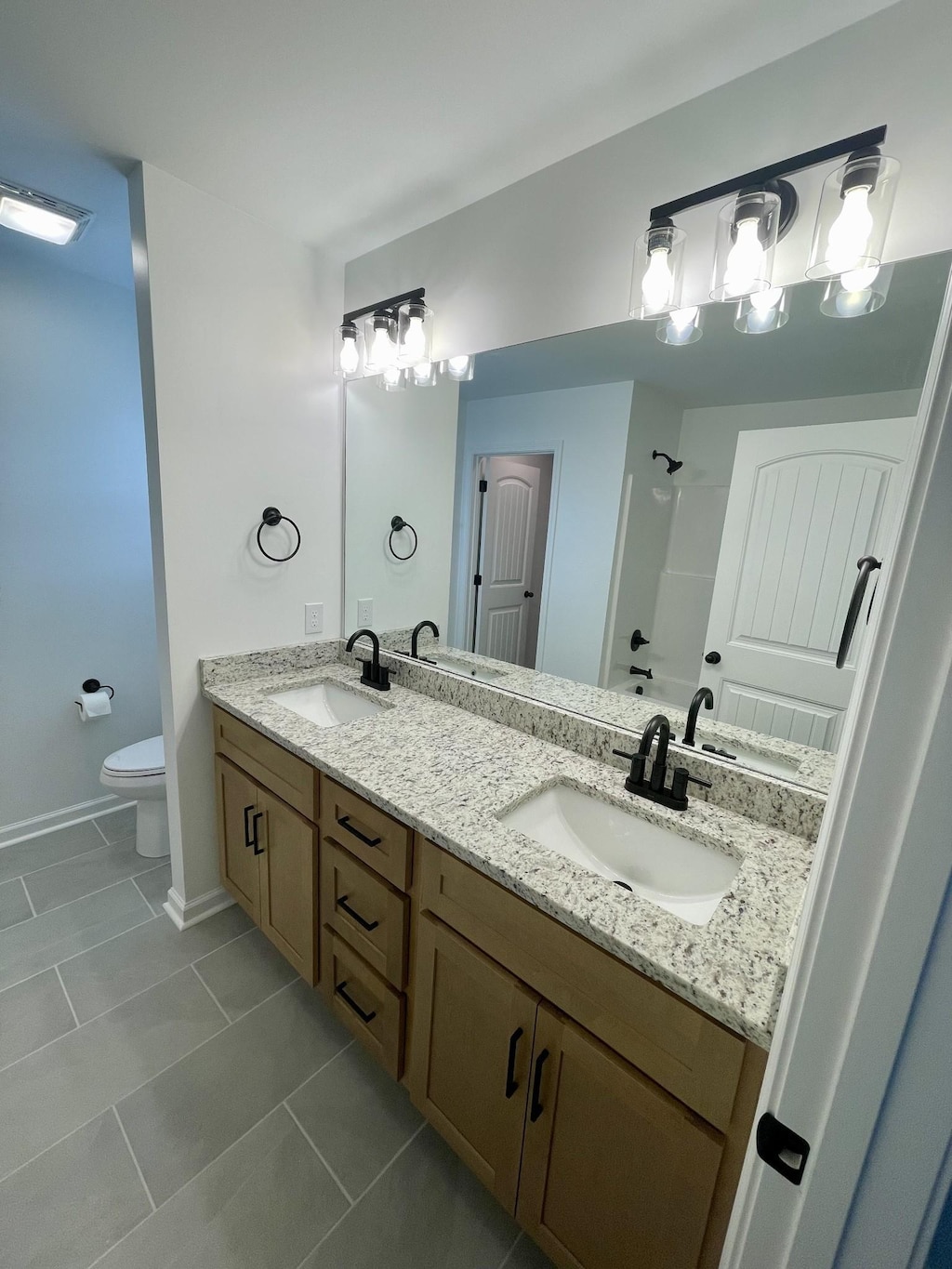 2798 Highland Rd, Lafayette, TN 37083 - bathroom featuring double vanity, tile patterned flooring, and a shower