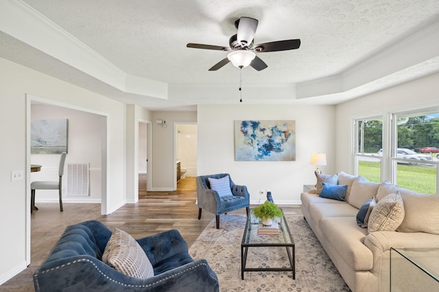 111 Platte Dr, Christiana, TN 37037 - living area with crown molding, a textured ceiling, a raised ceiling, ceiling fan, and wood finished floors