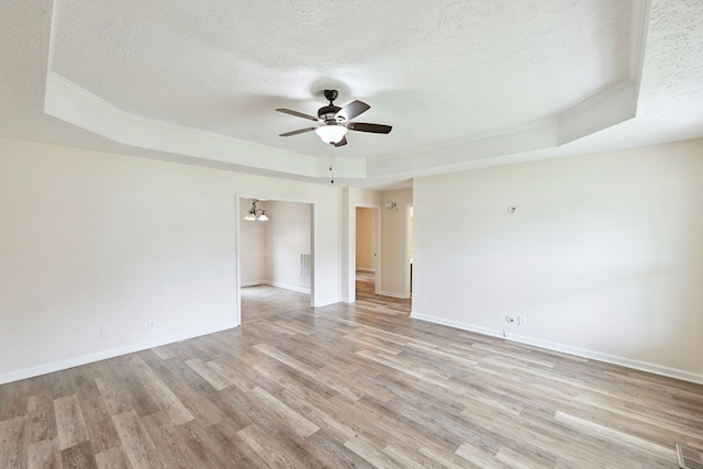 111 Platte Dr, Christiana, TN 37037 - spare room with a tray ceiling, crown molding, a ceiling fan, a textured ceiling, and light wood-style flooring