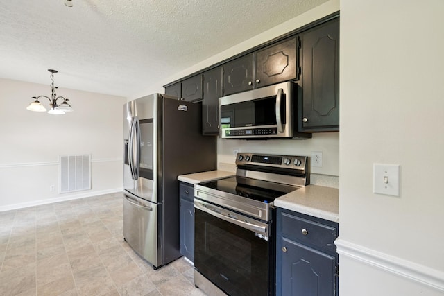 111 Platte Dr, Christiana, TN 37037 - kitchen featuring stainless steel appliances, light countertops, a chandelier, a textured ceiling, and decorative light fixtures