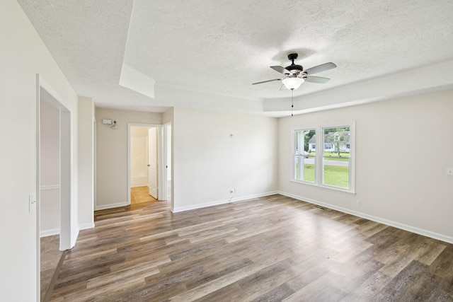 111 Platte Dr, Christiana, TN 37037 - empty room featuring a textured ceiling, ceiling fan, wood finished floors, and a tray ceiling