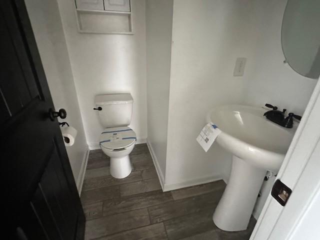 1248 Rich Ellen Dr, Palmyra, TN 37142 - half bathroom featuring toilet and wood finished floors