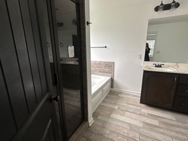 1248 Rich Ellen Dr, Palmyra, TN 37142 - bathroom featuring vanity, a shower stall, a bath, and wood finished floors