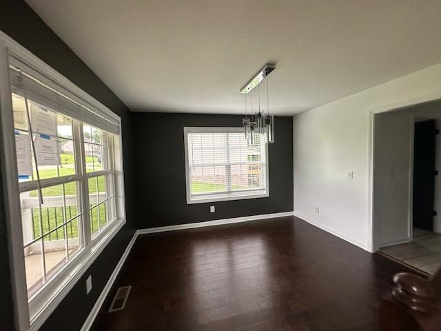 1248 Rich Ellen Dr, Palmyra, TN 37142 - unfurnished dining area with plenty of natural light, dark wood-style flooring, and a chandelier