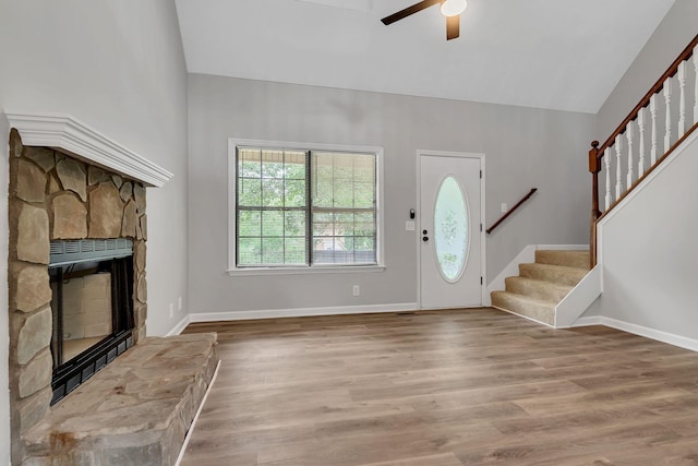 905 Septo Ct, Antioch, TN 37013 - foyer entrance featuring stairway, ceiling fan, a stone fireplace, vaulted ceiling, and wood finished floors