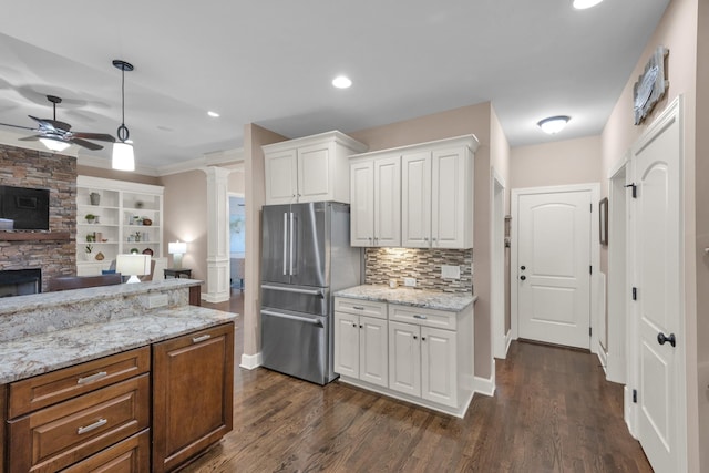 1794 Balvenie Ct, Brentwood, TN 37027 - kitchen with freestanding refrigerator, decorative columns, open floor plan, ceiling fan, and white cabinets