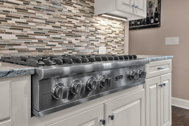 1794 Balvenie Ct, Brentwood, TN 37027 - kitchen view of stainless steel gas cooktop, tasteful backsplash, and white cabinetry