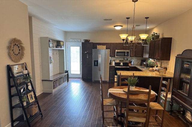 4803 Beryl Dr, Murfreesboro, TN 37128 - kitchen with appliances with stainless steel finishes, dark brown cabinetry, a chandelier, pendant lighting, and dark wood-style flooring