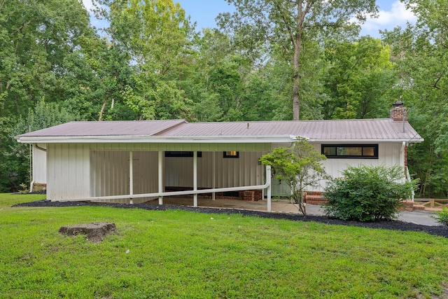 5920 Dogwood Dr, Harrison, TN 37341 - view of front facade featuring a front yard, a metal roof, and a chimney