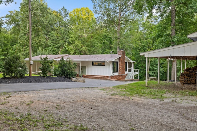 5920 Dogwood Dr, Harrison, TN 37341 - view of front of house with a chimney, asphalt driveway, a metal roof, and brick siding