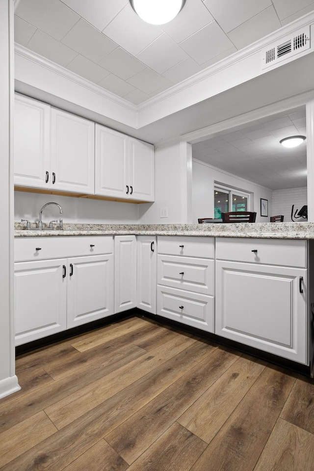 5920 Dogwood Dr, Harrison, TN 37341 - kitchen featuring ornamental molding, dark wood-style floors, white cabinets, and light stone countertops