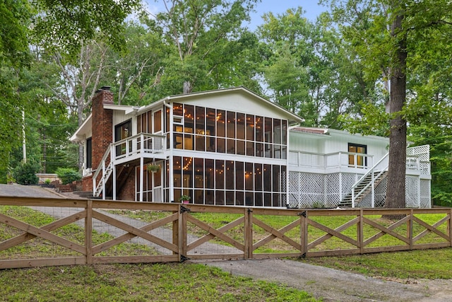 5920 Dogwood Dr, Harrison, TN 37341 - view of front of house with a sunroom, stairway, a chimney, and a deck