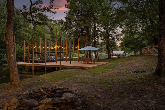 5920 Dogwood Dr, Harrison, TN 37341 - yard at dusk with a wooden deck and view of scattered trees