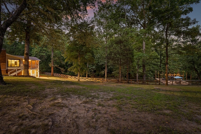 5920 Dogwood Dr, Harrison, TN 37341 - yard at dusk with a fenced backyard, stairs, and a deck