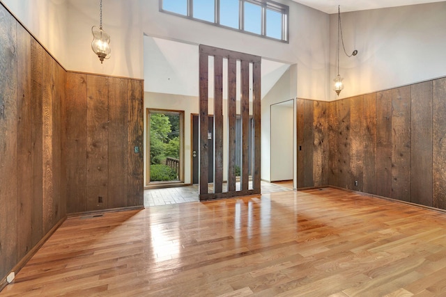 5122 Prince Phillip Cv, Brentwood, TN 37027 - entryway featuring wooden walls, wood finished floors, a towering ceiling, and wainscoting