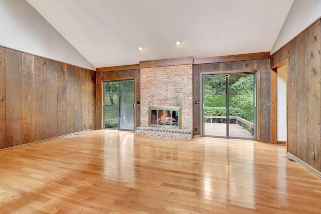 5122 Prince Phillip Cv, Brentwood, TN 37027 - unfurnished living room with wood walls, lofted ceiling, wood finished floors, and a fireplace