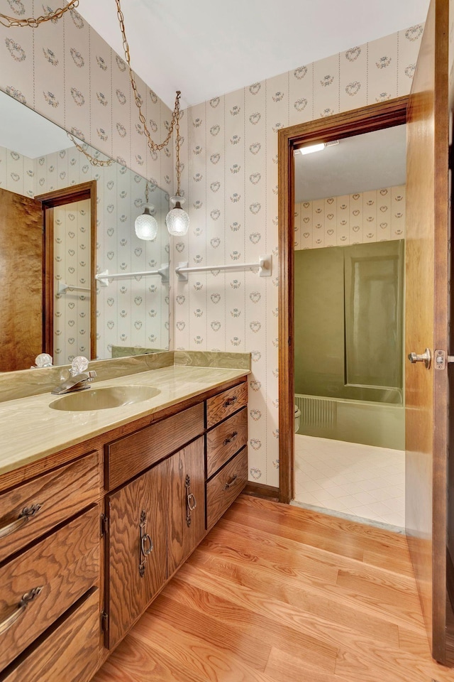 5122 Prince Phillip Cv, Brentwood, TN 37027 - bathroom with wallpapered walls, vanity, and wood finished floors