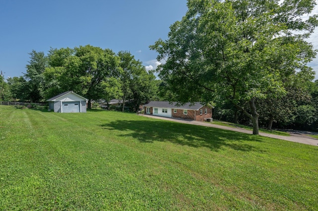 332 Old Dunbar Cave Rd, Clarksville, TN 37043 - view of grassy yard featuring a detached garage, an outdoor structure, and view of scattered trees