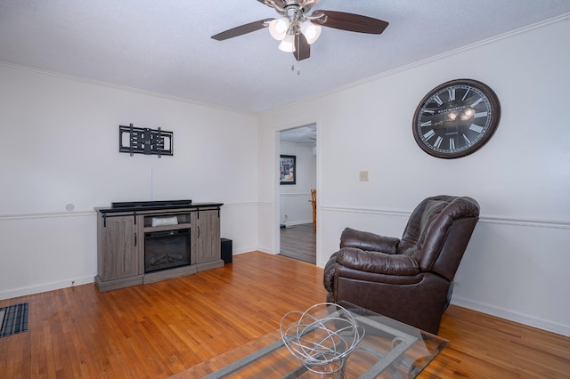332 Old Dunbar Cave Rd, Clarksville, TN 37043 - living area featuring ceiling fan, wood finished floors, and ornamental molding