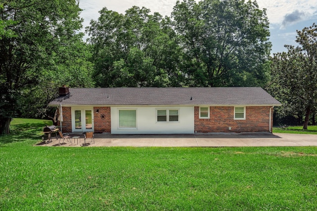 332 Old Dunbar Cave Rd, Clarksville, TN 37043 - back of property with brick siding, a patio area, a yard, french doors, and a chimney