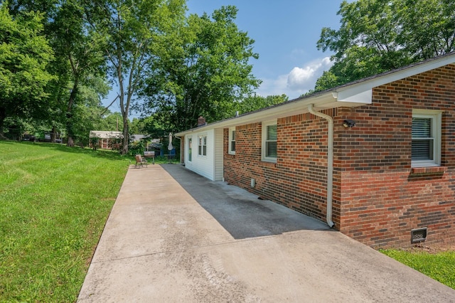 332 Old Dunbar Cave Rd, Clarksville, TN 37043 - view of property exterior featuring driveway, a lawn, brick siding, and crawl space