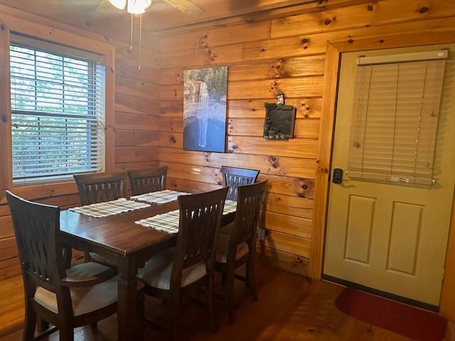 10 Meadow Brook Ln, Spencer, TN 38585 - dining room featuring wood finished floors, wooden walls, and a ceiling fan
