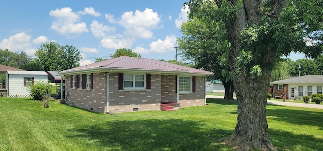 205 Galen Rd, Lafayette, TN 37083 - view of front of house with a front yard, brick siding, crawl space, and a metal roof