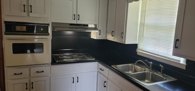 205 Galen Rd, Lafayette, TN 37083 - kitchen featuring oven, under cabinet range hood, electric stovetop, white cabinets, and dark countertops