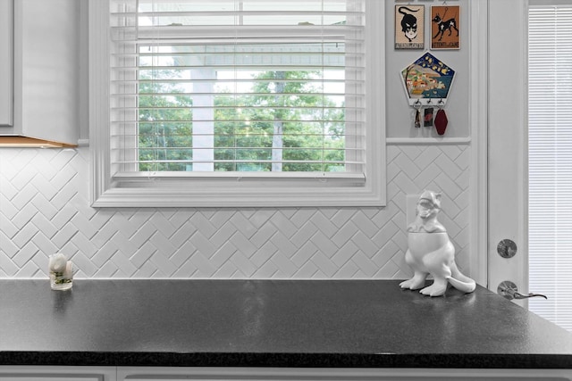 5086 Oop Rd, Chattanooga, TN 37416 - kitchen view of dark countertops, white cabinetry, and decorative backsplash