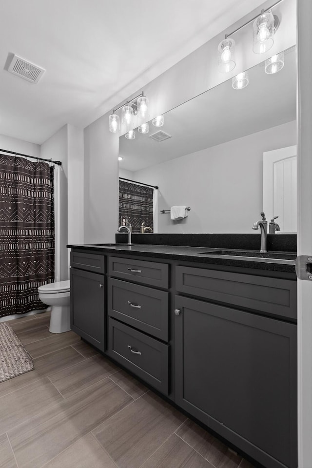 5086 Oop Rd, Chattanooga, TN 37416 - full bathroom with double vanity, wood finished floors, and a shower with curtain