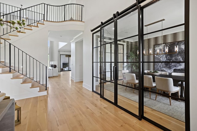 4720 Edwardian Trce, Franklin, TN 37067 - entrance foyer with hardwood / wood-style flooring, stairs, a towering ceiling, and a barn door