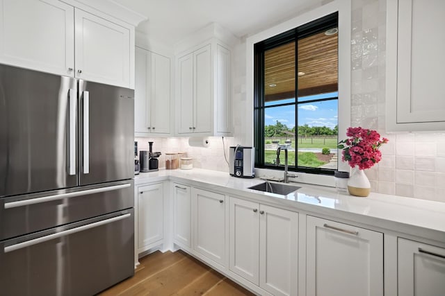 4720 Edwardian Trce, Franklin, TN 37067 - kitchen featuring freestanding refrigerator, tasteful backsplash, light countertops, and white cabinets