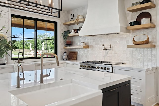 4720 Edwardian Trce, Franklin, TN 37067 - kitchen with open shelves, custom range hood, stove, tasteful backsplash, and light stone countertops