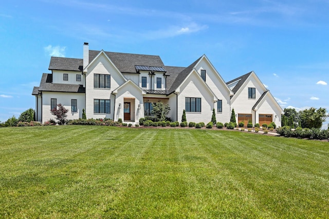 4720 Edwardian Trce, Franklin, TN 37067 - modern inspired farmhouse featuring a chimney, a standing seam roof, a front lawn, and a metal roof