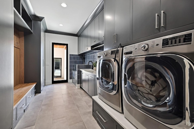 4720 Edwardian Trce, Franklin, TN 37067 - laundry room featuring cabinet space, washing machine and dryer, light tile patterned floors, recessed lighting, and ornamental molding
